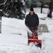A man snow blows the sidewalk after an overnight storm dumped several snow inches in Ann Arbor and surrounding areas on Wednesday, Feb. 27, 2013.  Melanie Maxwell I AnnArbor.com